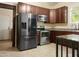 Modern kitchen with stainless steel appliances and dark wood cabinets at 1502 Bahama Rd, Bahama, NC 27503