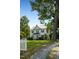 Two-story white house with a porch and landscaping at 1502 Bahama Rd, Bahama, NC 27503