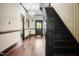 Dark wood staircase with a chandelier and hardwood floors at 1502 Bahama Rd, Bahama, NC 27503