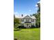Two-story white farmhouse with a lush green lawn at 1502 Bahama Rd, Bahama, NC 27503