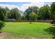 Large backyard with green grass and a wooden fence at 1502 Bahama Rd, Bahama, NC 27503