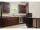 Modern kitchen with stainless steel appliances and dark wood cabinets at 1502 Bahama Rd, Bahama, NC 27503