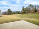 Spacious, grassy backyard with a concrete patio at 1208 Randwick Valley Ct, Zebulon, NC 27597