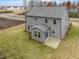 Aerial view of gray two-story home with sunroom and fenced backyard at 1208 Randwick Valley Ct, Zebulon, NC 27597