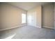 Spacious bedroom with carpet, window, and double-door closet at 400 S Eastwood Dr, Benson, NC 27504