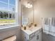 Clean bathroom with a vanity, large mirror, and view of the backyard at 464 Cresting Wave Dr # 380, Wake Forest, NC 27587