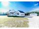 White farmhouse with detached garage at 997 Jackson Rd, Fuquay Varina, NC 27526