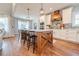Kitchen island with wooden base and black barstools, white quartz countertop at 997 Jackson Rd, Fuquay Varina, NC 27526