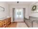 Bright bedroom with crib and wooden dresser, hardwood floors at 997 Jackson Rd, Fuquay Varina, NC 27526