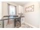 Laundry room with washer, dryer, and herringbone tile floor at 997 Jackson Rd, Fuquay Varina, NC 27526