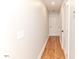 Long hallway with hardwood floors and neutral walls at 997 Jackson Rd, Fuquay Varina, NC 27526