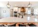 Modern kitchen features white cabinets, a wooden range hood, and patterned backsplash at 997 Jackson Rd, Fuquay Varina, NC 27526
