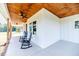 Inviting front porch with rocking chairs and wood ceiling at 997 Jackson Rd, Fuquay Varina, NC 27526