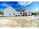White farmhouse exterior with covered porch and large backyard at 997 Jackson Rd, Fuquay Varina, NC 27526