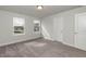 Well-lit bedroom featuring neutral walls and gray carpet at 591 Glenkirk Pl # 106, Garner, NC 27529