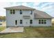 Two story home with gray siding, a patio, and landscaping at 591 Glenkirk Pl # 106, Garner, NC 27529