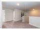 Upstairs hallway with carpet and access to bedrooms at 591 Glenkirk Pl # 106, Garner, NC 27529