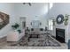 Open living room with high ceilings, fireplace and view of staircase at 591 Glenkirk Pl # 106, Garner, NC 27529