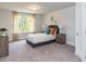 Bright bedroom with gray carpet, double windows, and neutral decor at 591 Glenkirk Pl # 106, Garner, NC 27529