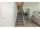 Elegant staircase with iron balusters leading to the upper level at 591 Glenkirk Pl # 106, Garner, NC 27529