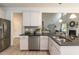 Modern kitchen with white cabinets, granite countertops, and stainless steel appliances at 591 Glenkirk Pl # 106, Garner, NC 27529