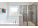 Bathroom with soaking tub and walk-in shower at 591 Glenkirk Pl # 106, Garner, NC 27529