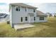 Two-story house, gray siding, patio, and backyard view at 591 Glenkirk Pl # 106, Garner, NC 27529