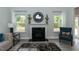 Living room features a fireplace and large windows at 591 Glenkirk Pl # 106, Garner, NC 27529