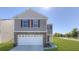 Two-story house with a stone facade and a white garage door at 2001 Puffin Dr # 201, Haw River, NC 27258