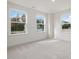 Well-lit bedroom with neutral carpeting and large windows at 122 Whimbrel Ct, Lillington, NC 27546