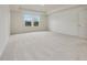 Well-lit bedroom with carpeted floors and large windows at 122 Whimbrel Ct, Lillington, NC 27546