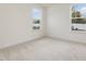 Bright bedroom with neutral carpeting and two windows at 122 Whimbrel Ct, Lillington, NC 27546