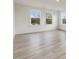 Spacious bedroom with hardwood floors and large windows offering natural light at 122 Whimbrel Ct, Lillington, NC 27546