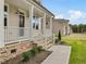 Covered porch with stone base and white railings at 122 Whimbrel Ct, Lillington, NC 27546