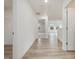 Light-filled hallway featuring hardwood floors and access to bedrooms at 122 Whimbrel Ct, Lillington, NC 27546