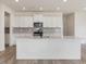 Spacious kitchen island with white cabinets and quartz countertops at 122 Whimbrel Ct, Lillington, NC 27546