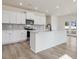 Modern kitchen with white cabinets, quartz countertops, and stainless steel appliances at 122 Whimbrel Ct, Lillington, NC 27546
