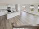 Open concept kitchen with island and stainless steel appliances at 122 Whimbrel Ct, Lillington, NC 27546