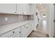 White kitchen cabinets, quartz countertops and gray tile backsplash at 122 Whimbrel Ct, Lillington, NC 27546