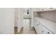 Kitchen features white cabinets, gray backsplash and spacious pantry at 122 Whimbrel Ct, Lillington, NC 27546
