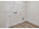 Convenient laundry room with built-in shelving and space for a washer and dryer at 122 Whimbrel Ct, Lillington, NC 27546