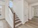 Modern staircase with wooden steps and white railing at 122 Whimbrel Ct, Lillington, NC 27546
