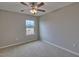 Simple bedroom with ceiling fan and large window at 199 Grand Griffon Way, Lillington, NC 27546