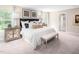 Bright and airy primary bedroom featuring a king-size bed and ensuite bathroom access at 313 Mason Oaks Dr, Wake Forest, NC 27587