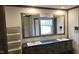 Double vanity bathroom with a large mirror and wood-look floors at 3027 Nc Highway 210, Smithfield, NC 27577