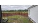 Large backyard with wooden fence and open field view at 3027 Nc Highway 210, Smithfield, NC 27577