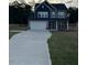 Two-story home with gray siding, a two-car garage, and a paved driveway at 6104 Sunset Lake Rd, Fuquay Varina, NC 27526