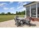 Relaxing patio with fire pit and seating area, overlooking the backyard at 1468 Lassiter Pond Rd, Four Oaks, NC 27524