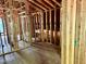 Unfinished upstairs bedroom with exposed framing and a large window at 255 Roberts Ave, Henderson, NC 27537