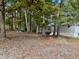 Manufactured home nestled in a wooded area with ample yard space at 255 Roberts Ave, Henderson, NC 27537